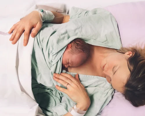 A mother and her newborn baby in hospital after birth